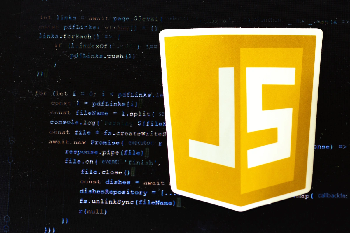 JavaScript logo over some example code