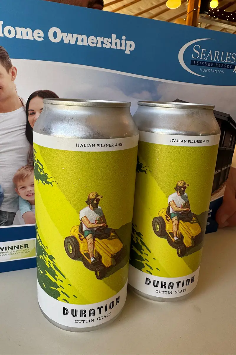 Two cans of Duration Cuttin' Grass Italian Pilsner