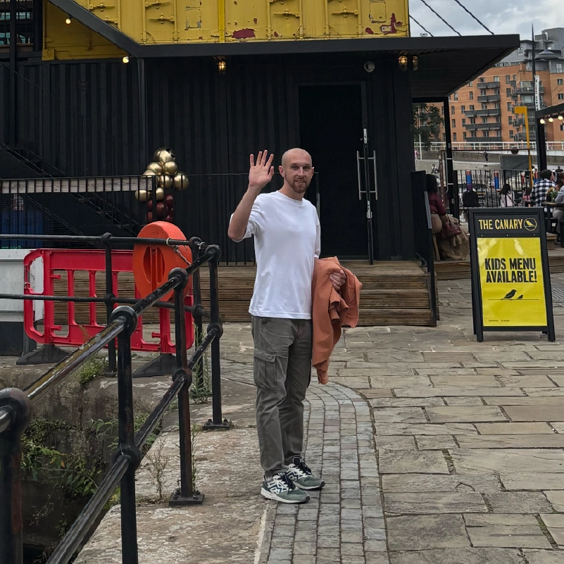 Liam waving outside the canary in Leeds