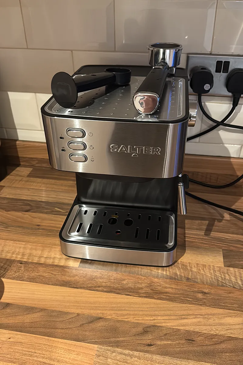 Manual coffee machine sitting on a kitchen counter