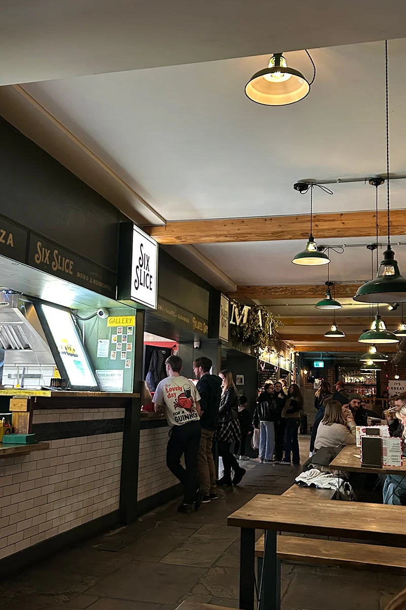 Food stalls and seating inside Northern Market in Leeds
