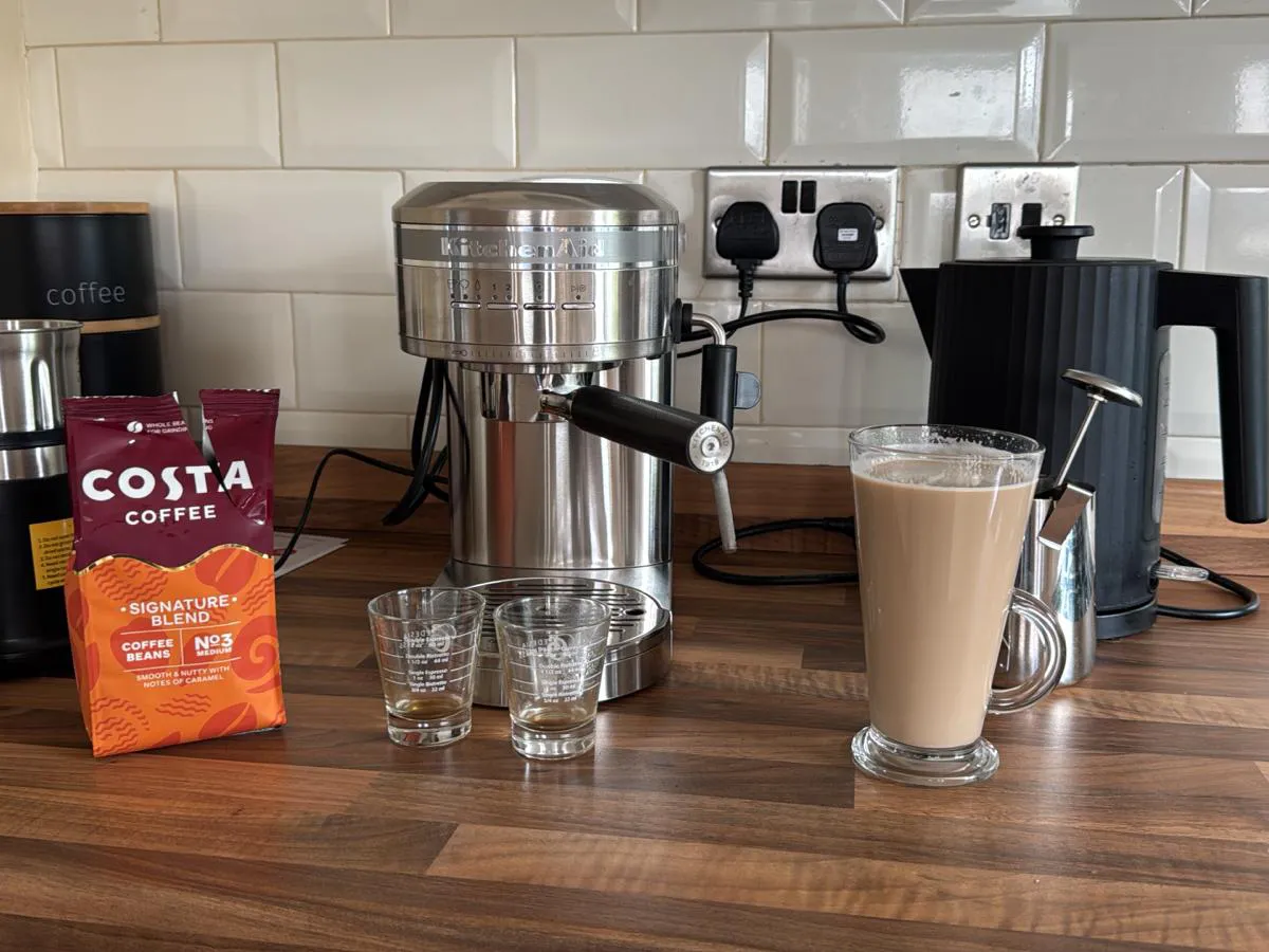 Coffee machine and a latte on the kitchen side