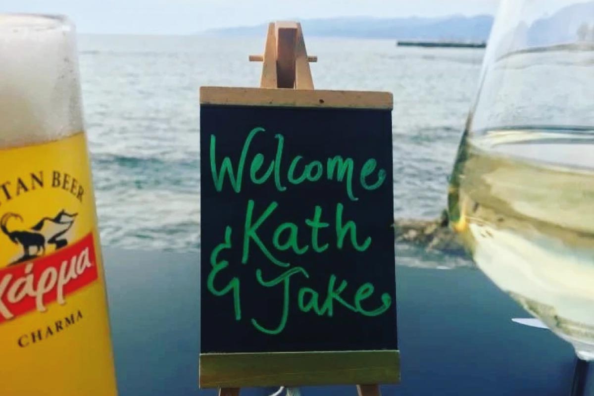 a beer and a wine with a sign saying welcome kath & jake