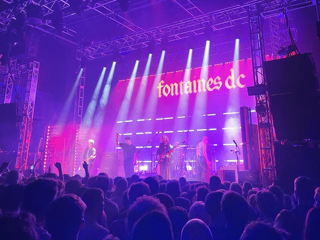 fontaines DC playing live on a purple lit stage