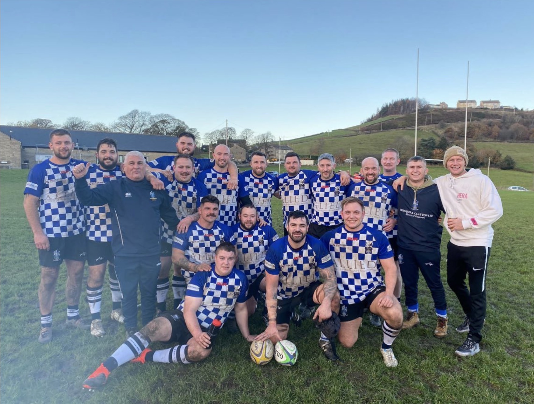 a rugby team photo with players in blue and white jerseys