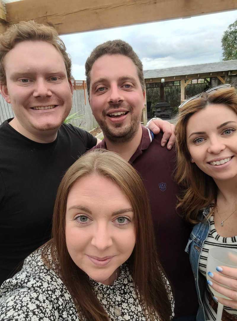 two couples taking a selfie outside