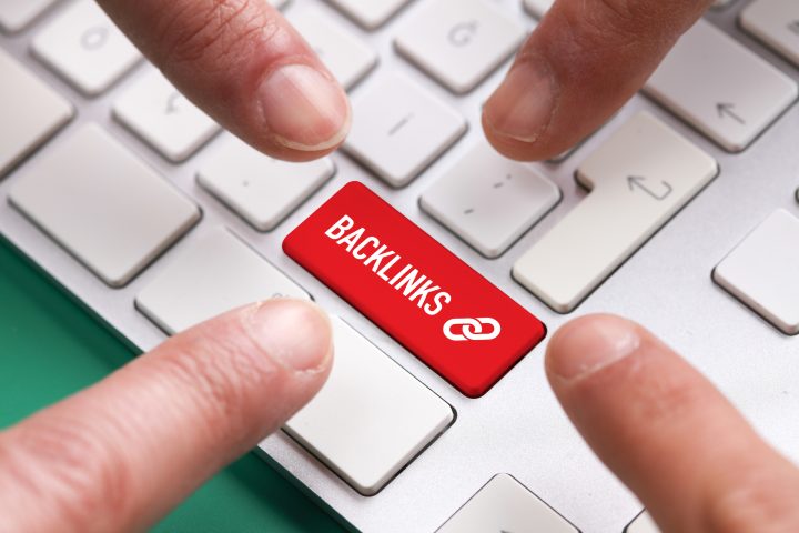 Many fingers pushing red backlinks keyboard button